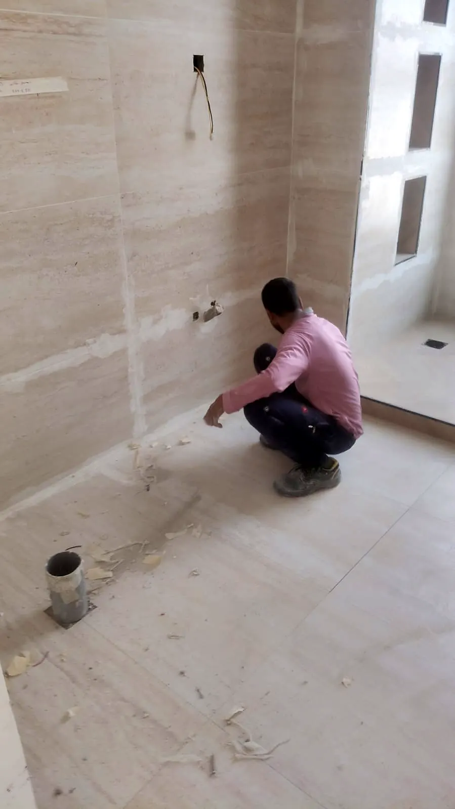 Installing wall tiles in a villa bathroom