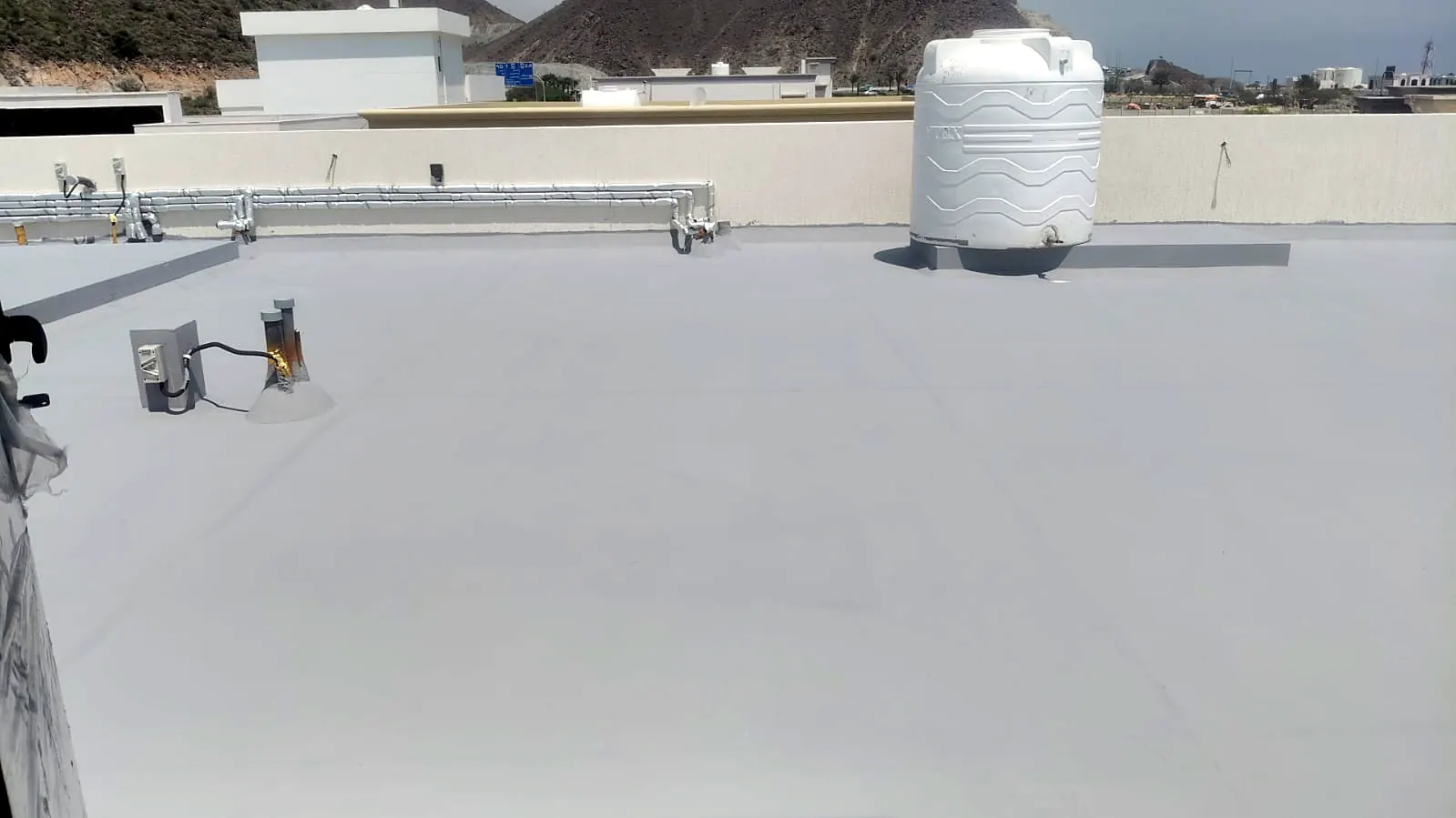 Completed roof waterproofing with water tank and service connections