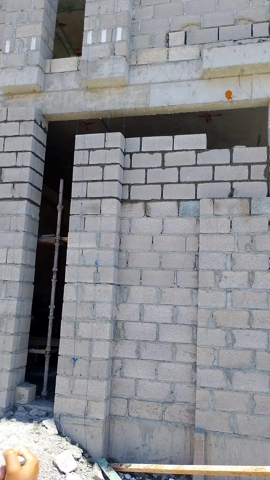 Concrete blockwork wall rising around an opening