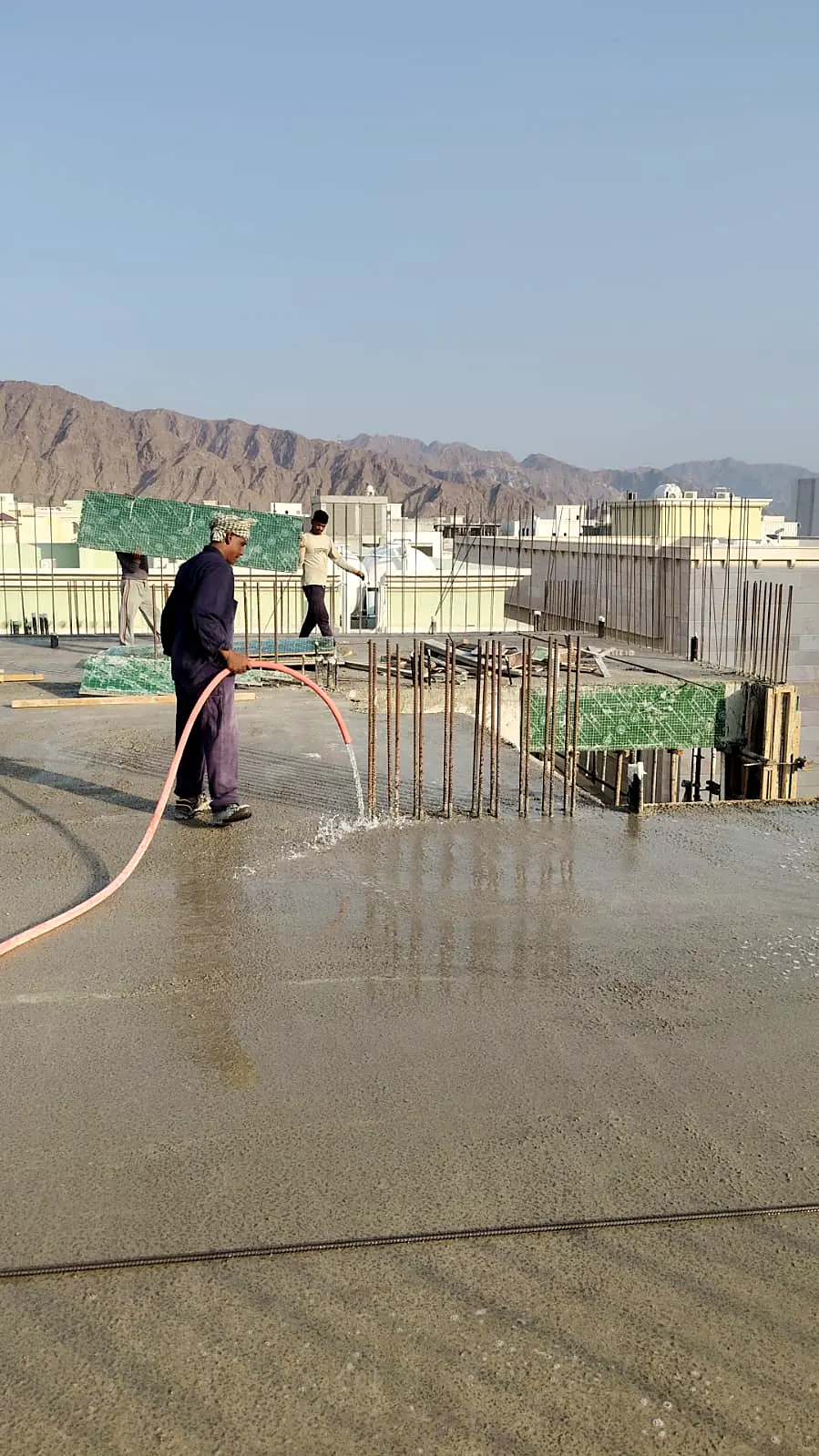 Fresh concrete slab being cured with water