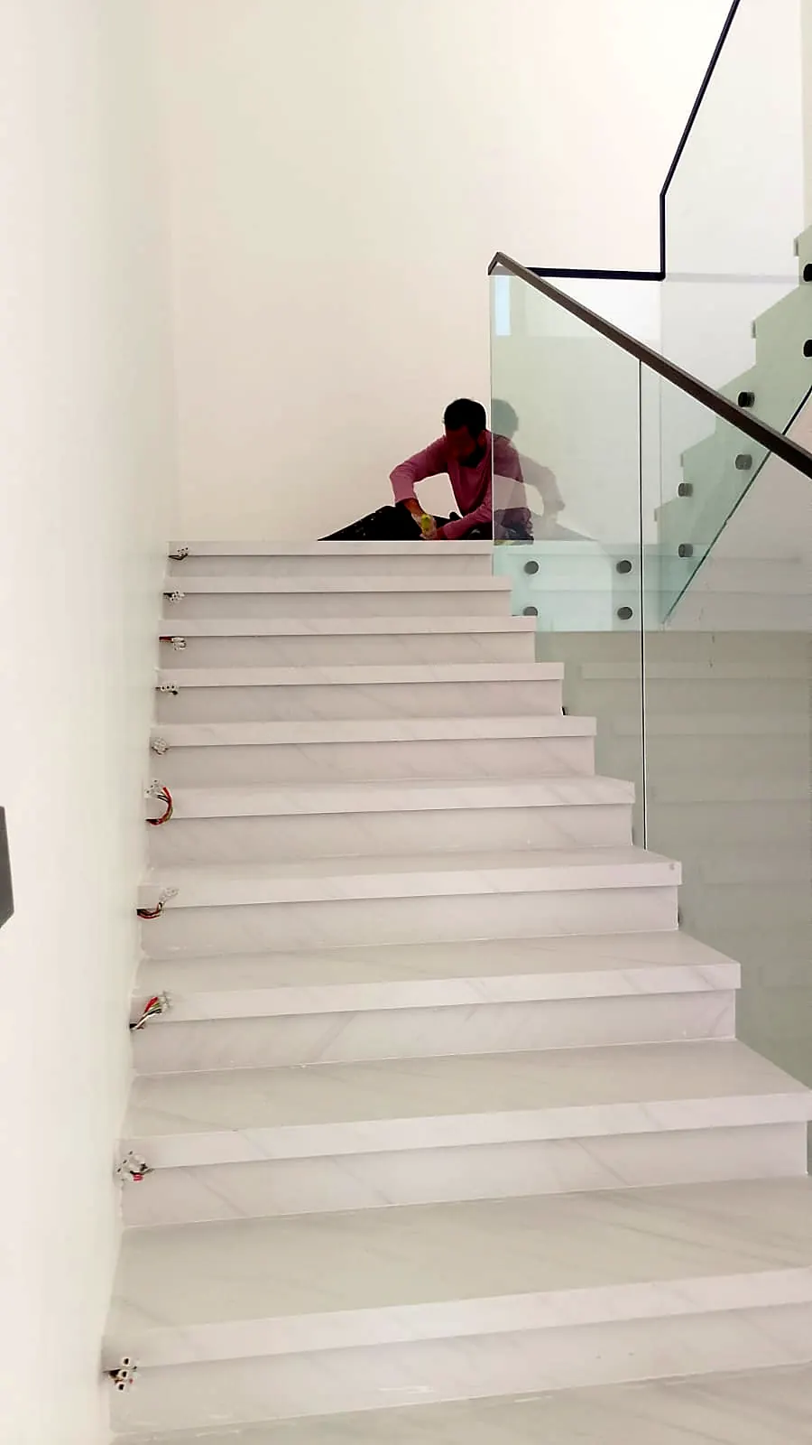 Marble staircase with a frameless glass balustrade