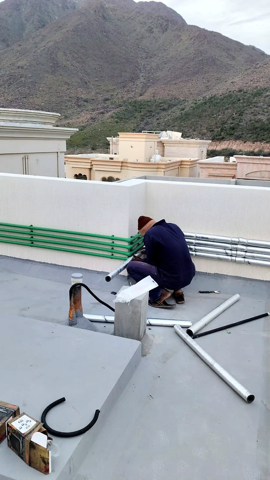 Plumbing pipework being installed on a finished roof
