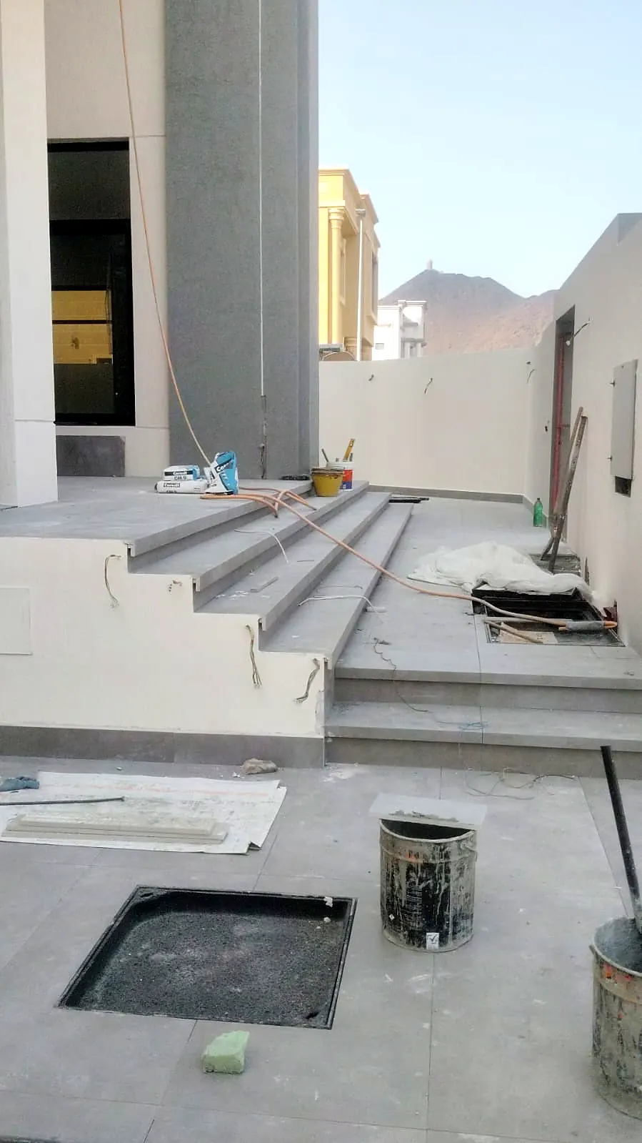 Stepped stone terrace with drainage outlets at a villa entrance