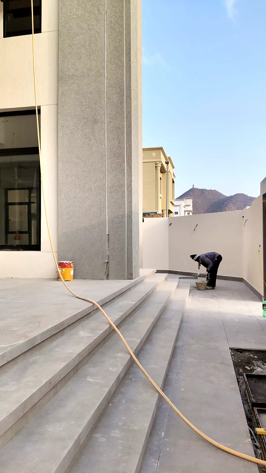 Grey stone external stairs and terrace being finished