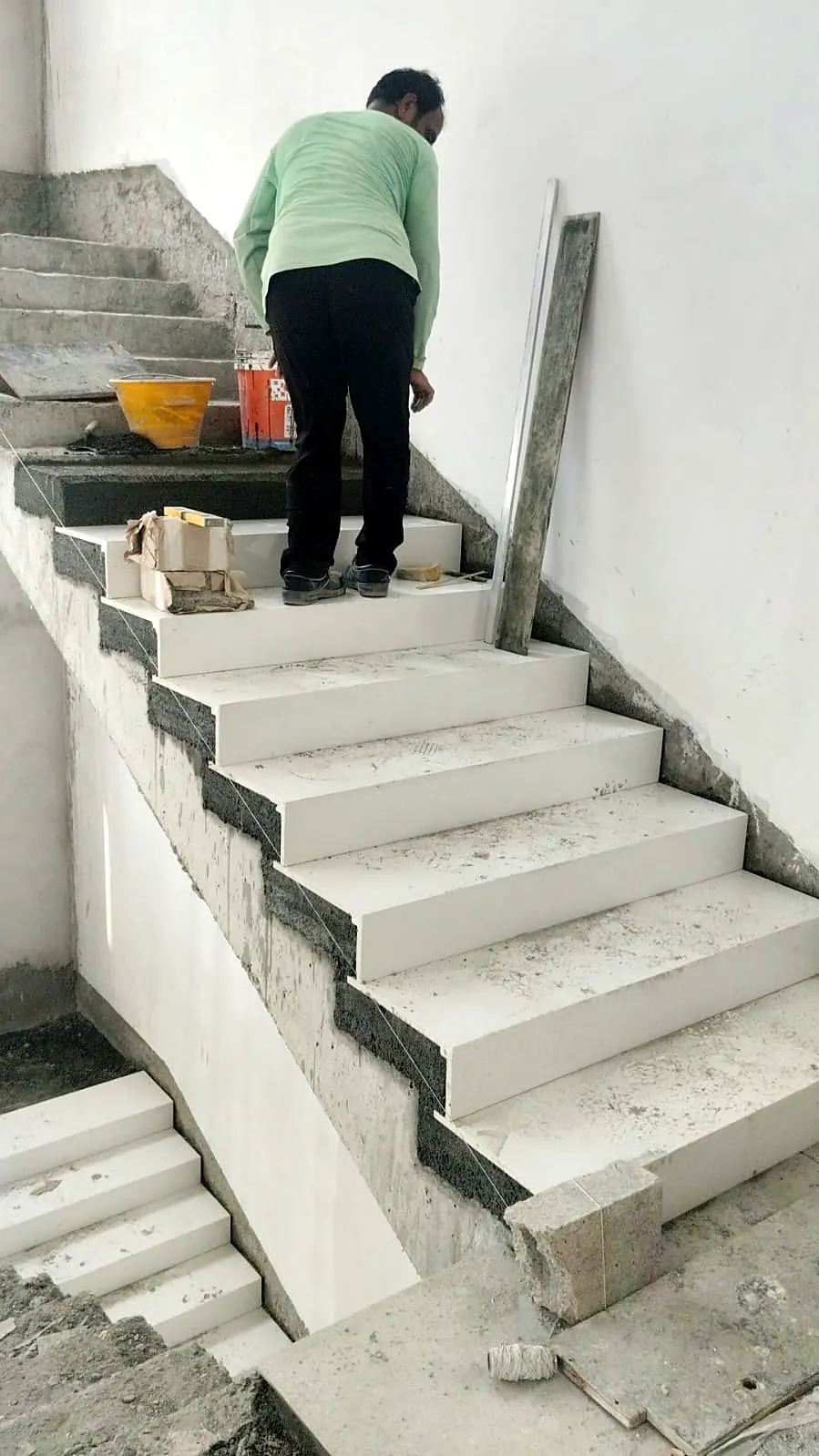 Mason laying stone stair treads