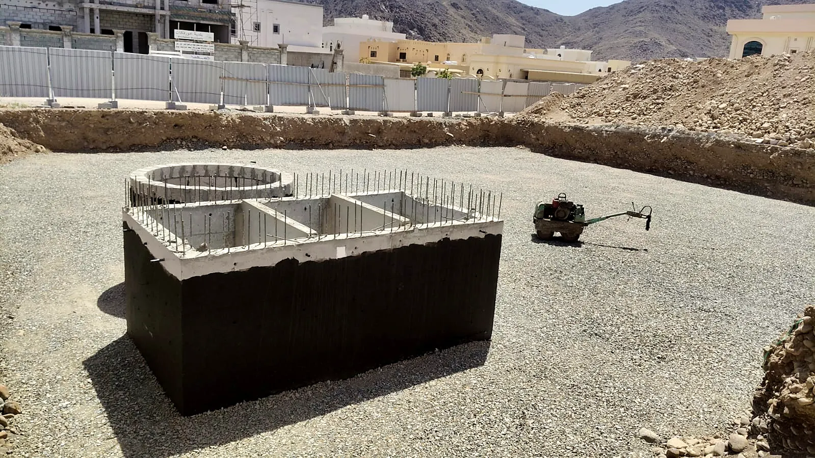 Underground concrete tank with coated walls built on a levelled villa plot